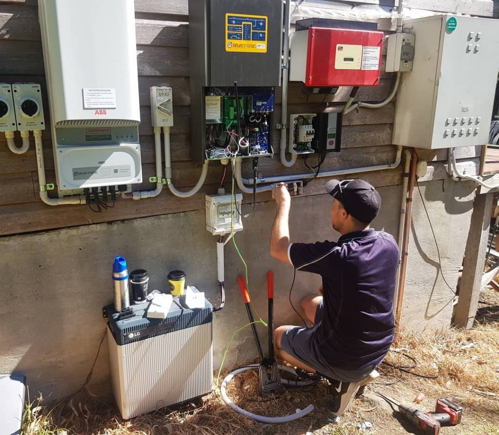 Sky Energy expert installing a solar battery