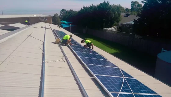 Electricians installing solar panels